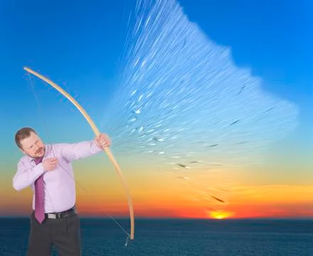 Businessman practicing archery on sunset background Stock Photos