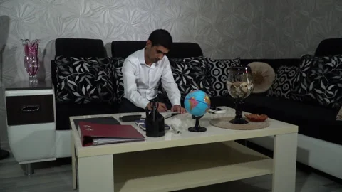 Businessman practicing his activities while sitting on the sofa at home Stock Footage 245084978