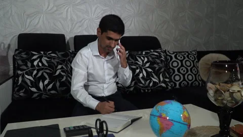 Businessman practicing his activities while sitting on the sofa at home Stock Footage 245084984