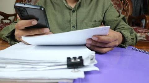 Businessman Preparing reports papers. Piles of unfinished document achieves.. Stock Photos