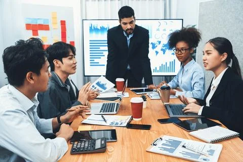 Businessman presenting data analysis dashboard on TV at meeting room. Concord Stock Photos