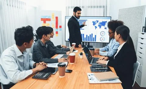 Businessman presenting data analysis dashboard on TV at meeting room. Concord Stock Photos
