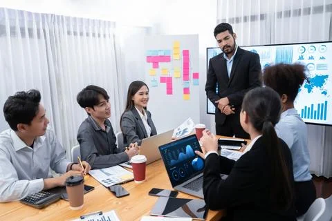 Businessman presenting data analysis dashboard on TV at meeting room. Concord Stock Photos