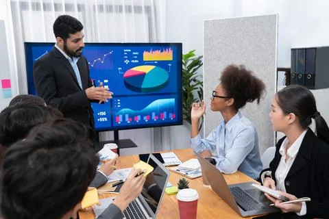 Businessman presenting data analysis dashboard on TV at meeting room. Concord Stock Photos