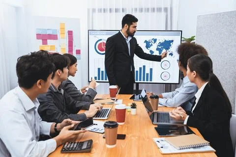 Businessman presenting data analysis dashboard on TV at meeting room. Concord Stock Photos