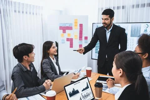 Businessman presenting data analysis dashboard on TV at meeting room. Concord Stock Photos