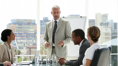 Businessman presenting to his team who applaud him Stock Footage