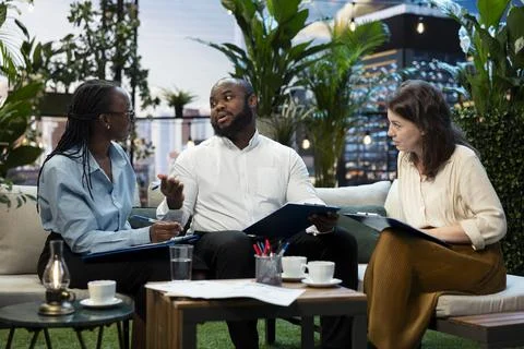 Businessman presenting proposal during rooftop team discussion Stock Photos
