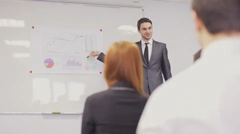 Businessman presenting to the team taking notes in the boardroom. Video stock 59829936