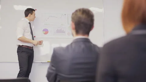 Businessman presenting to the team taking notes in the boardroom. Static shot Stock Footage 59830214