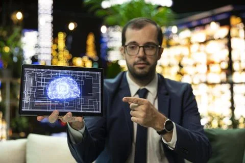 Businessman presents AI interface on tablet and points toward screen Stock Photos