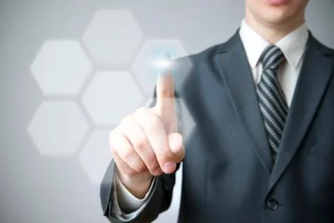 Businessman presses a button on the touch screen イラスト素材