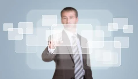 Businessman presses virtual button Stock Photos
