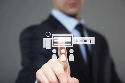 Businessman pressing button on touch screen interface and select Training Stock Photos