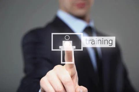 Businessman pressing button on touch screen interface and select Tutoring Stock Photos