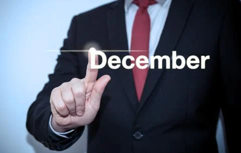 Businessman pressing button on virtual screen December button - concept Stock Photos