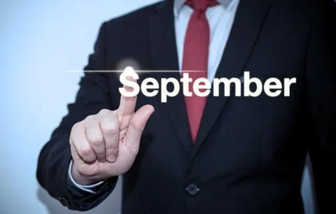 Businessman pressing button on virtual screen September button - concept Stock Photos