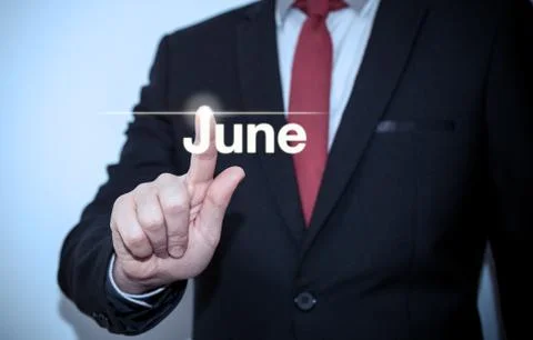 Businessman pressing button on virtual screen June button - concept Stock Photos