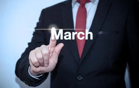 Businessman pressing button on virtual screen March button - concept Stock Photos