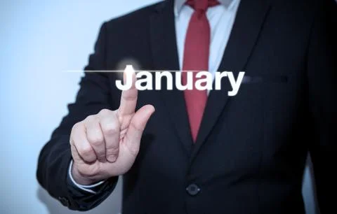 Businessman pressing button on virtual screen January button - concept Stock Photos