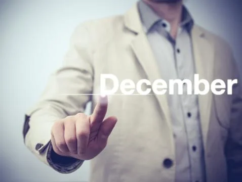 Businessman pressing button on virtual screen December button - concept Stock Photos