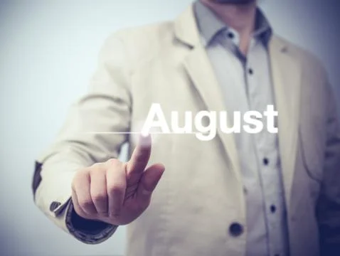 Businessman pressing button on virtual screen August button - concept Stock Photos