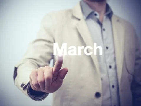 Businessman pressing button on virtual screen March button - concept Stock Photos