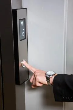 Businessman pressing elevator button Fotos de archivo