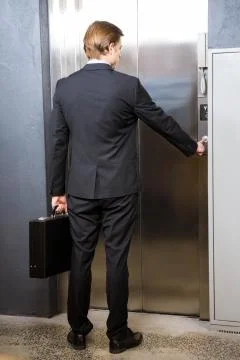Businessman pressing elevator button Foto stock