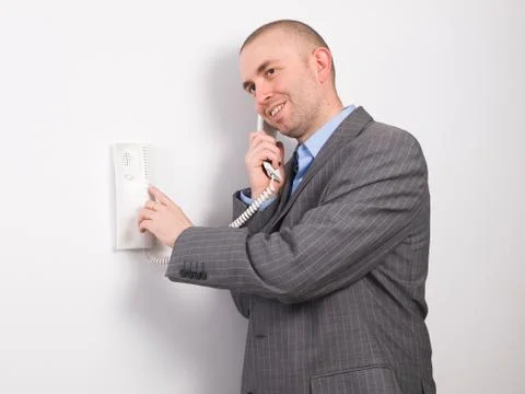 Businessman pressing an intercom Stock Photos