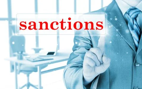 Businessman pressing sanctions button on virtual screens Illustrazione stock
