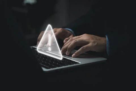 Businessman programmer, developer using laptop computer with triangle cauti.. Stock Photos