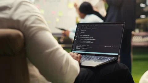 Businessman programmer using binary code on laptop during informal work 写真素材
