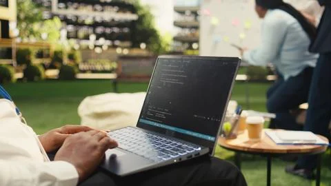 Businessman programmer using binary code on laptop during informal work Stock Photos