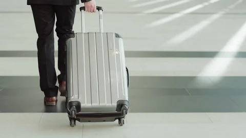 Businessman pulling suitcase in airport Stock Footage 108681908