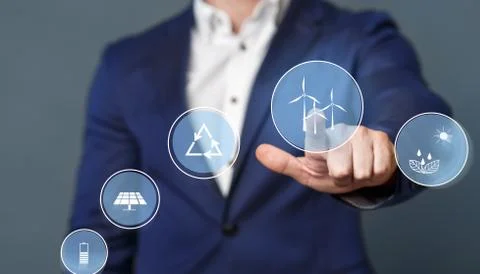 Businessman pushing virtual button with windmill icon Stock Photos