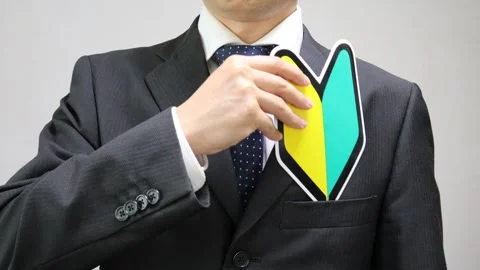 A businessman puts a beginner driver sticker in his suit pocket. Stock Footage 335732531