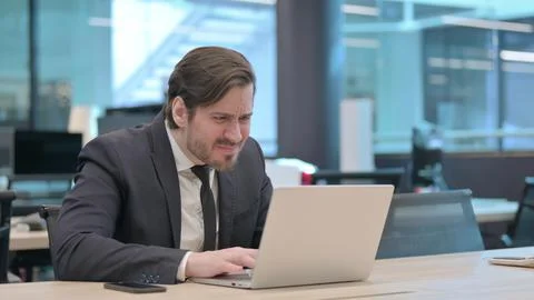 Businessman Reacting to Loss While using Laptop Stock Photos