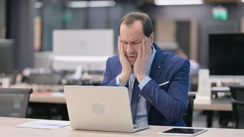 Businessman Reacting to Loss While using Laptop Stock Photos
