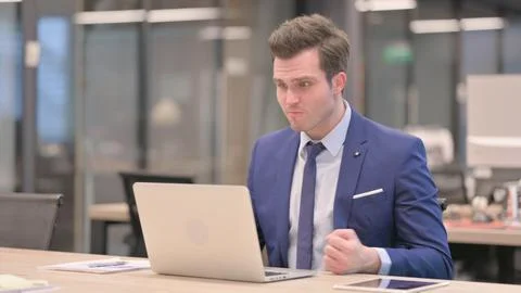 Businessman Reacting to Loss While using Laptop Stock Photos