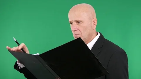 Businessman Read and Write Financial Data in a Folder Stock Footage 82500490