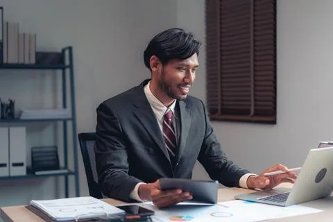 Businessman read data on tablet to checking financial and accounting report.. Stock-Fotos