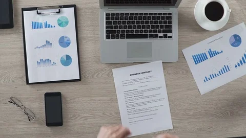 Businessman reading and signing business contract, office work, top view Stock Footage