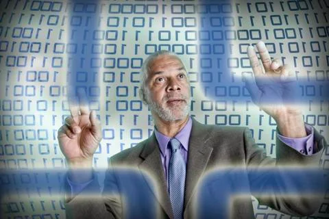 Businessman reading binary code Stock Photos