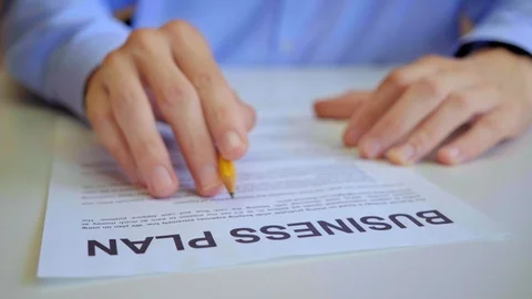 Businessman reading business plan document in office Stock Footage 115855831