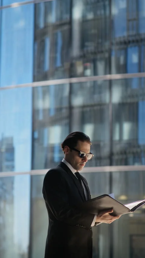 Businessman Reading Documents, Checking Watch Outdoors Video stock 339447674