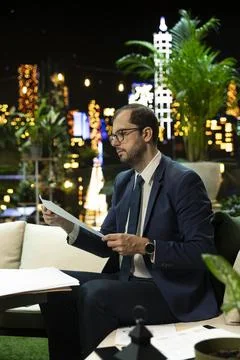 Businessman reading financial document at table for corporate success Stock Photos