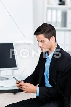 Businessman reading a message on his mobile Stock Photos