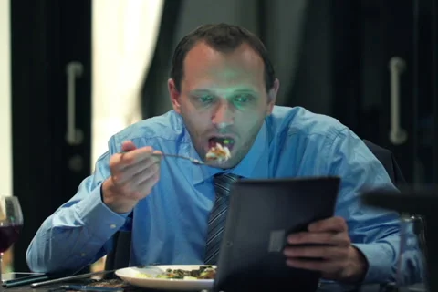 Businessman reading news on tablet computer during dinner at home NTSC Stock Footage 41967950