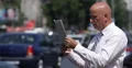 Businessman Reading Newspaper City Busy Street Cars Passing Traffic Man Standing 4k or 4k+ Resolution